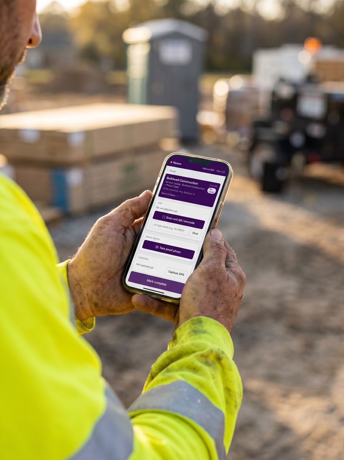 A driver in the field using the Throne app on a phone